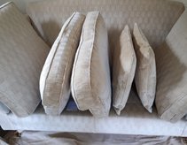 Showing how the cushions should be stacked on a sofa when cleaning has been completed and they will be left to dry