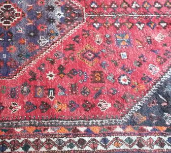 An Iranian wool rug that had been cleaned with a dry compound due to the dyes being likely to run if water was used
