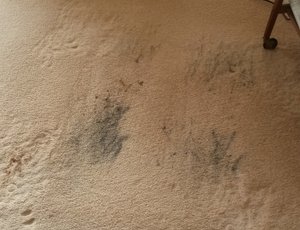 This shows a polypropylene carpet which has oil stains from an electric rising armchair