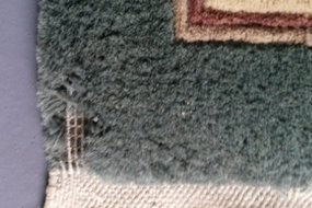 A wool rug with extensive moth damage link to moth treatments